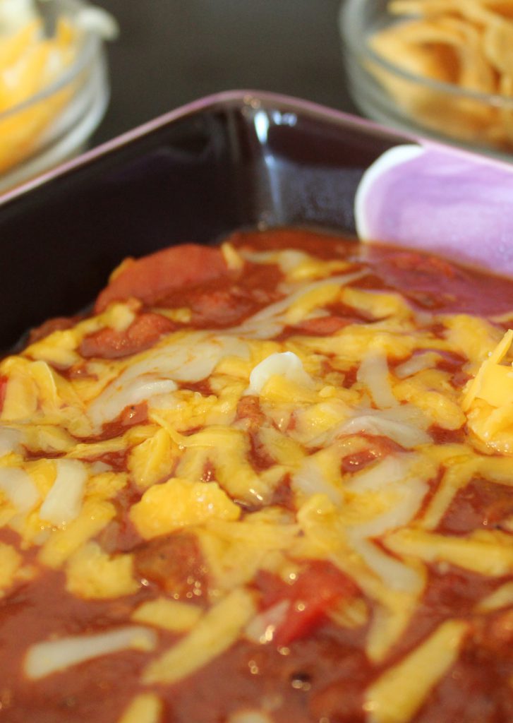 It is imperative to melt cheese into the chili. It forms a base for the other toppers to hold onto. Plus melted cheese, come on. 