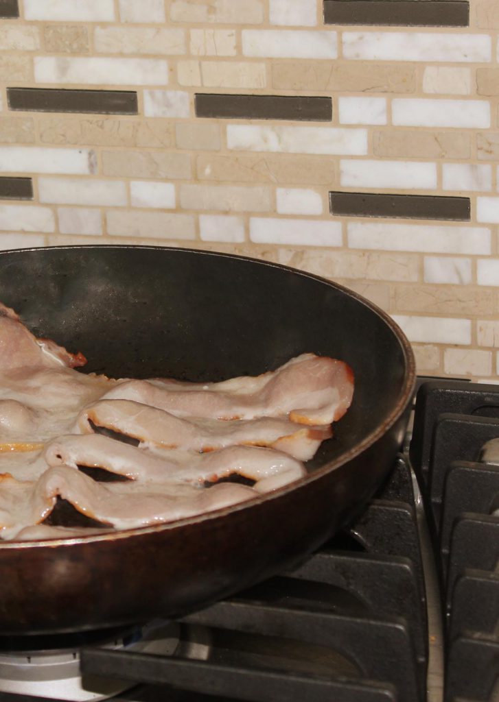 Fry bacon over medium heat. Remember you can use another way to fry it such as a griddle or microwave bacon griller but you do need the bacon fat for caramelizing the onions.