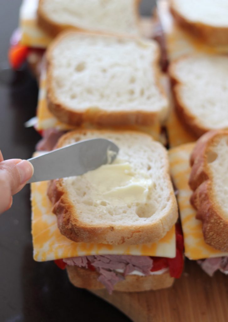 Butter the tops. And when this side is grilling, butter the other side. 