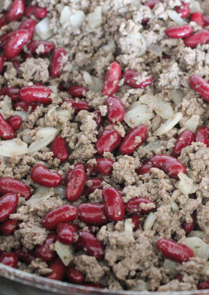 This is after the meat has cooked with the onions, fat has been drained, seasonings and beans have been added. Ground beef isn't the prettiest but this looks pretty good. 