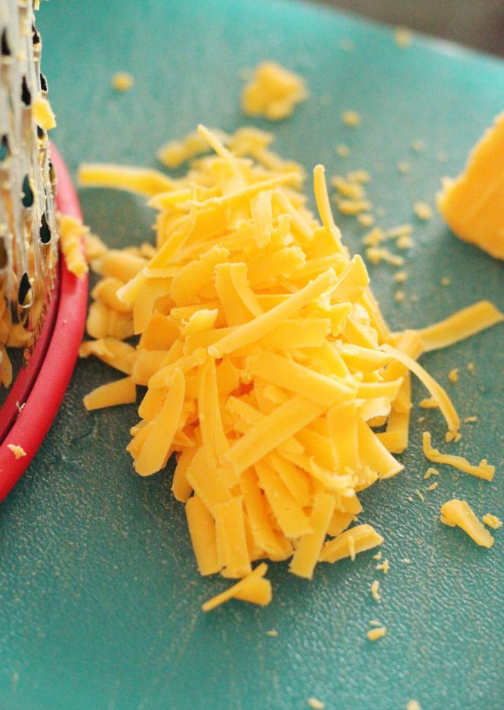 I like to shred my cheese by hand. It assures that it is gluten free and that my finger muscles are worked out.  They are very conscientious about their workouts. 